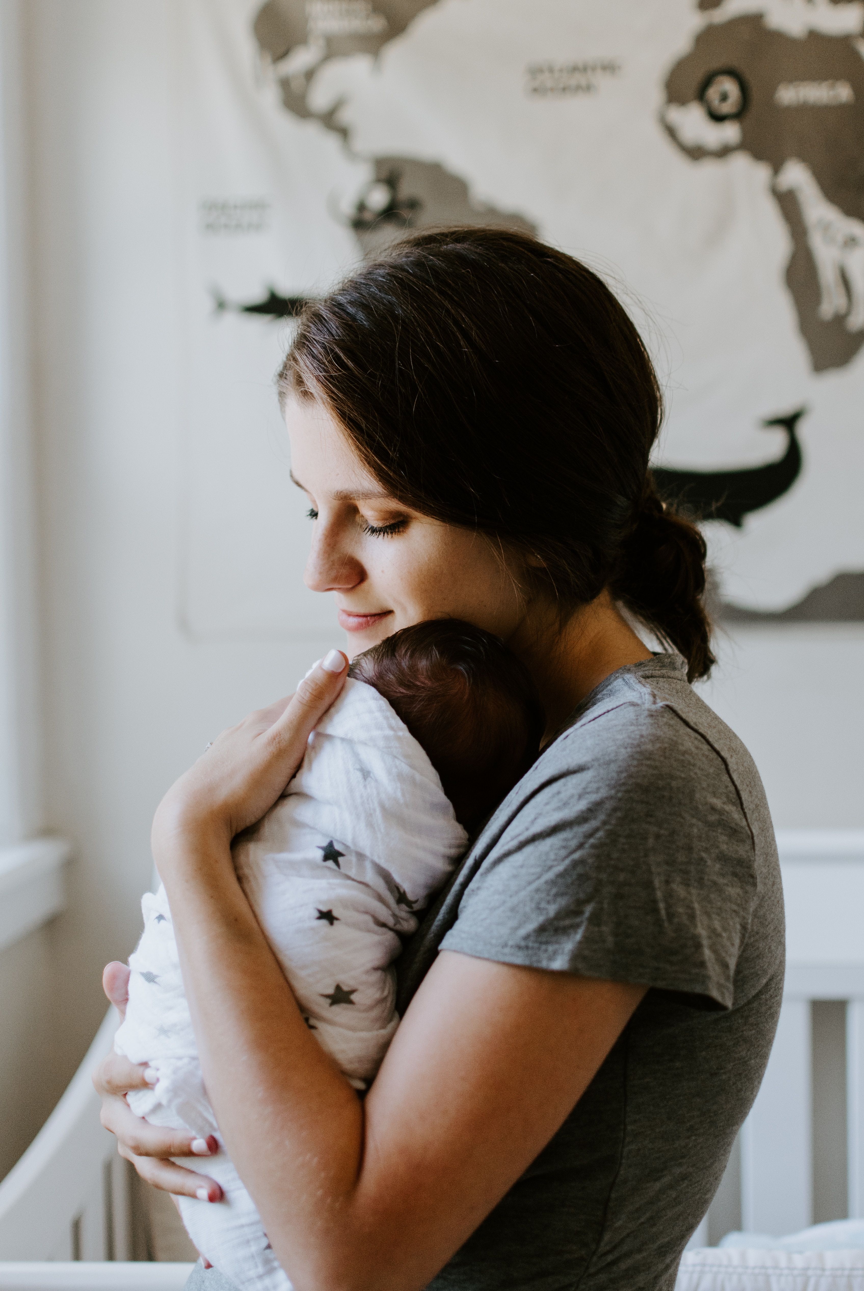 mom holding baby smiling